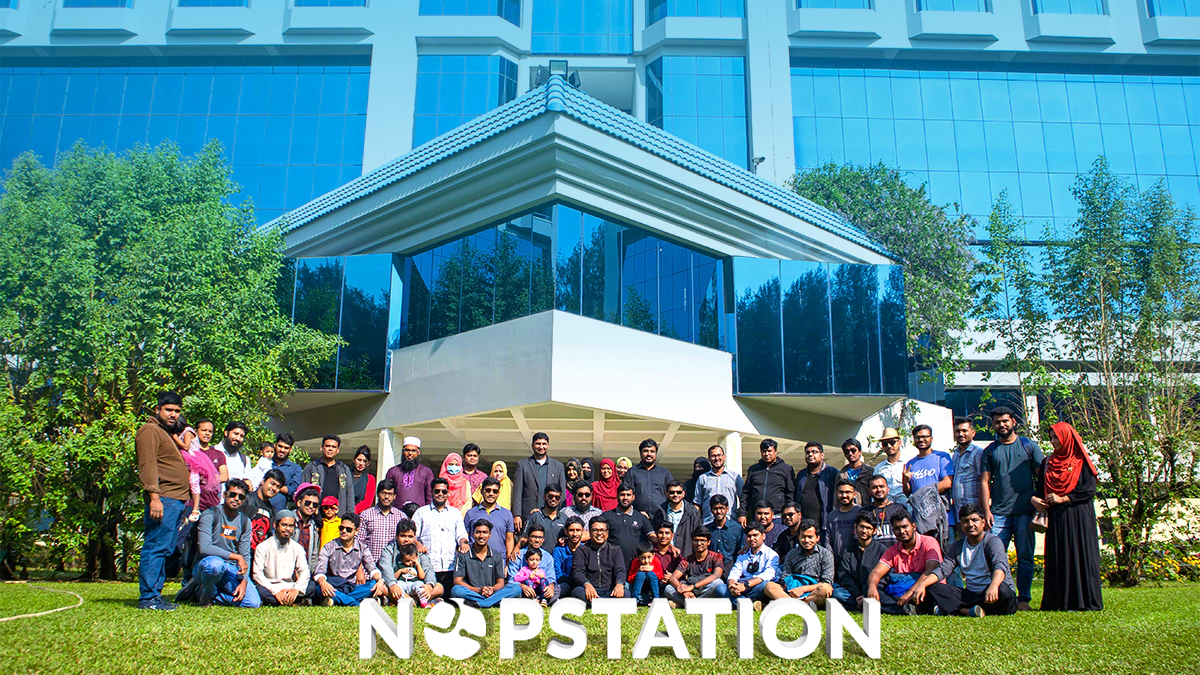 Team of professionals posing in front of a modern office building